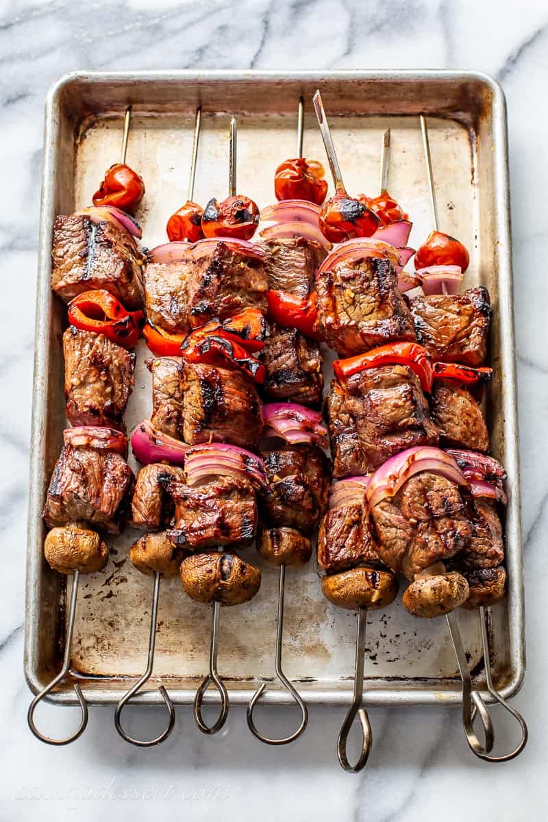 Cooked and grilled steak kabobs on a baking tray