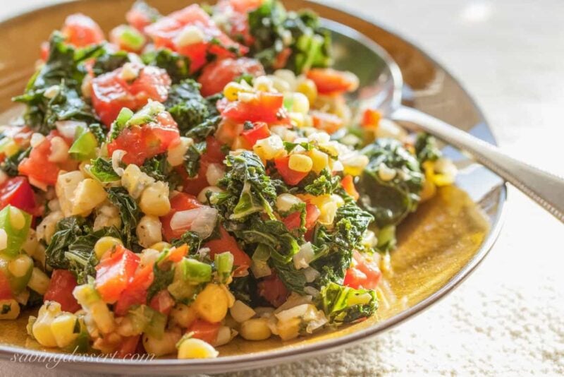 A bowl of Cajun flavored kale, corn and tomatoes 