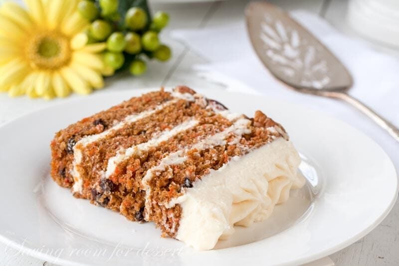 A slice of 4-layer carrot cake on a plate