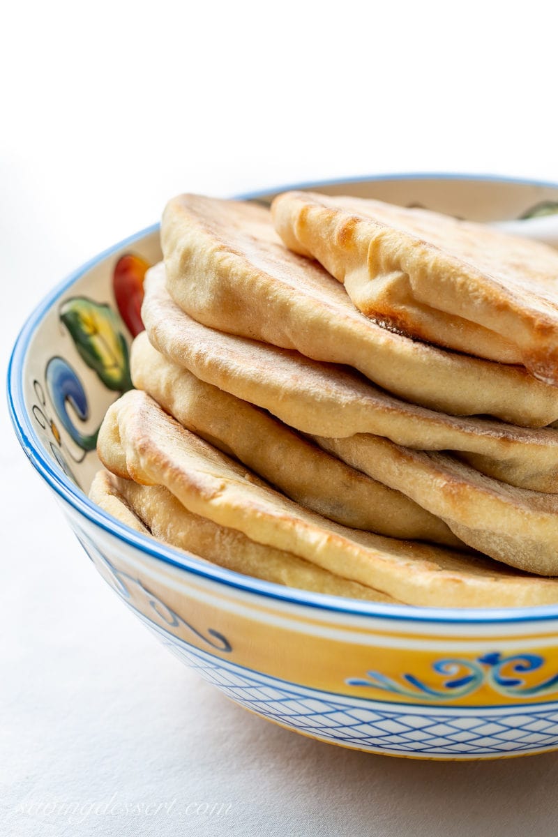 A bowl of fresh homemade whole wheat pita breads