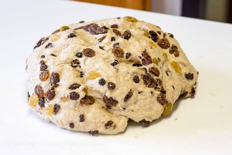 A round ball of bread dough filled with raisins, currants and golden raisins