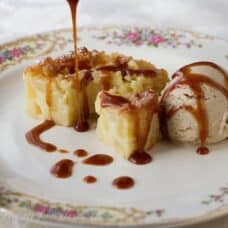 front view of half cake, ice cream scoop with glaze drizzled