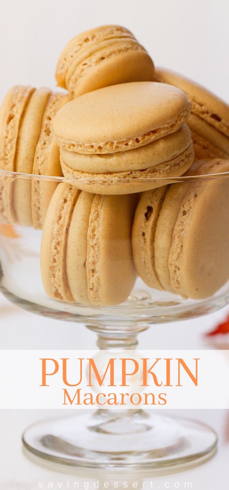 A glass filled with pumpkin macarons 