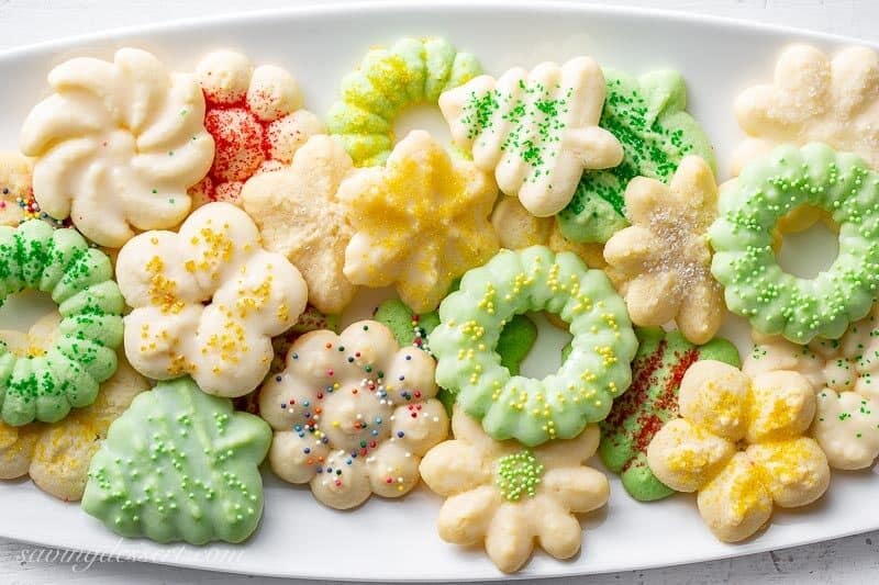 A platter of colorful Spritz Cookies made using a cookie press