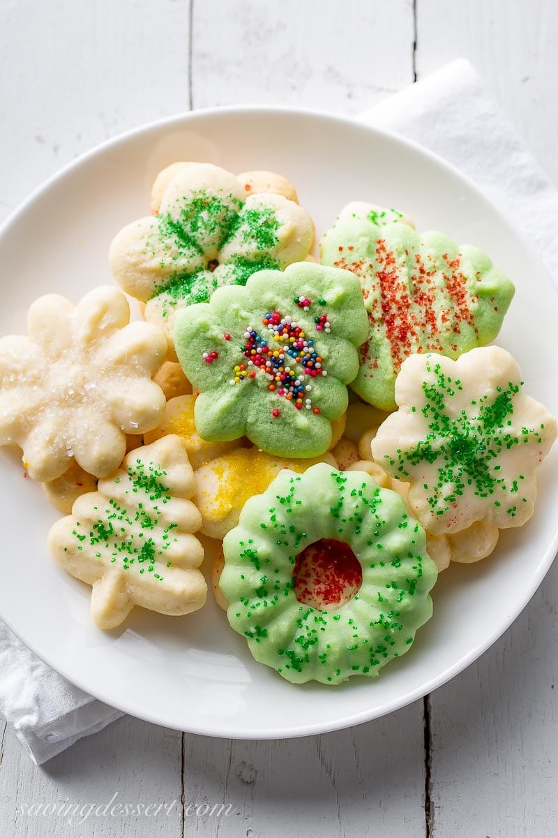 A plate of decorated Spritz cookies in a variety of shapes