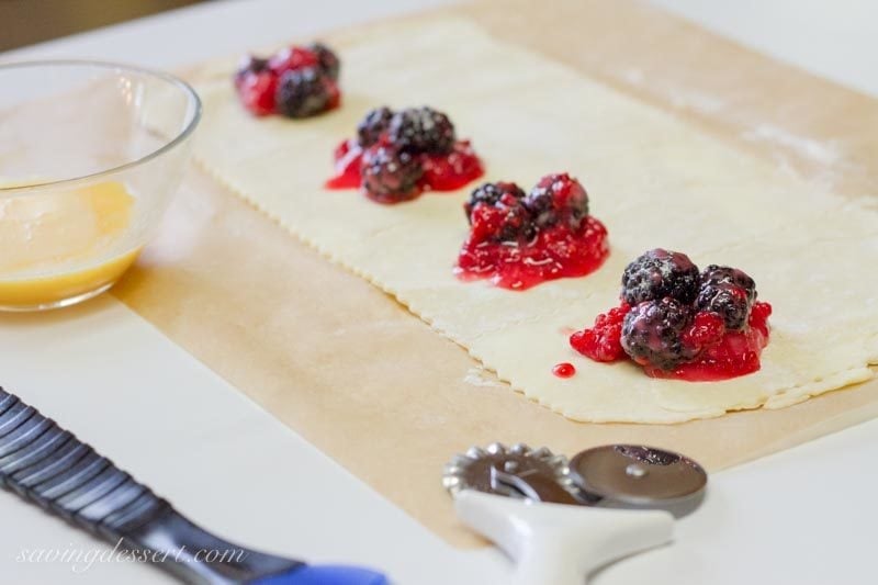 mixed fruit on top of pastry dough