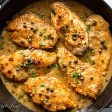 A skillet of chicken piccata with capers