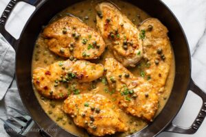 A skillet of chicken piccata with capers