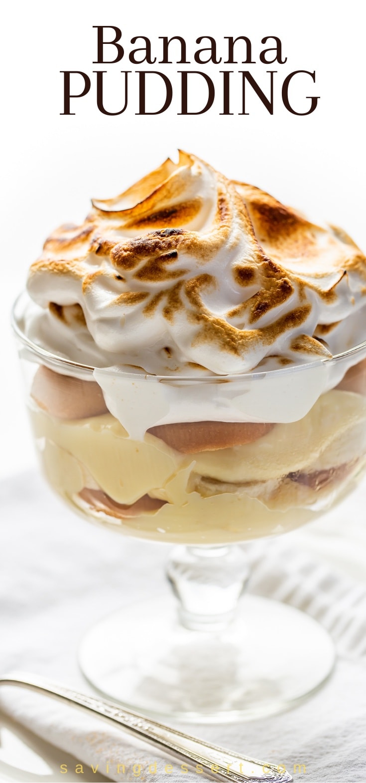close up of a mini-trifle bowl filled with banana pudding topped with meringue