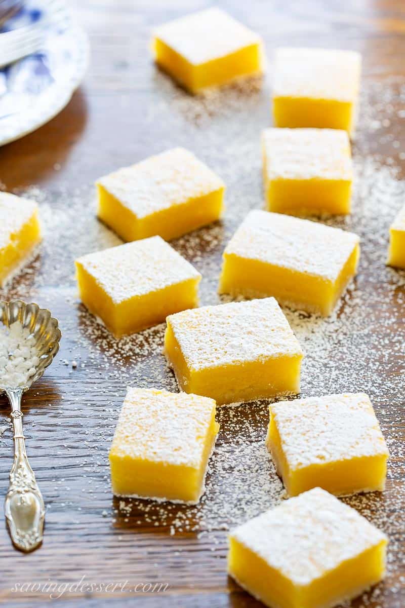 Lemon Bars cut into squares and sprinkled with powdered sugar