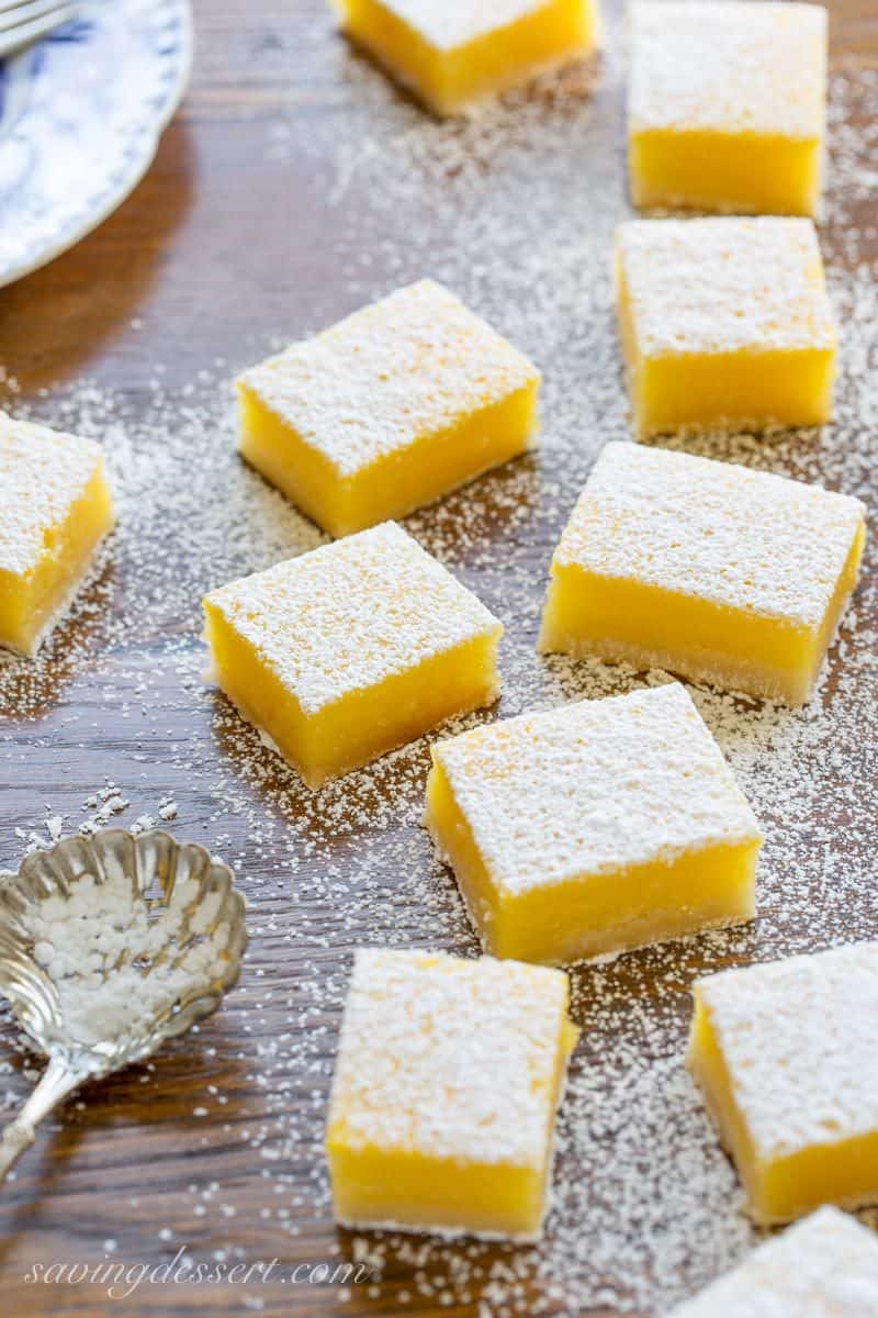Lemon Bars cut into squares dusted with powdered sugar