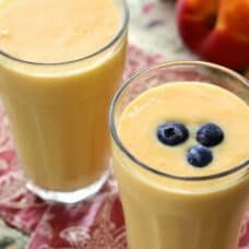 top view of two smoothies in a glass and blueberries atop one