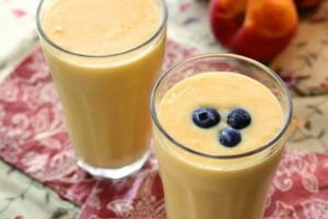 top view of two smoothies in a glass and blueberries atop one