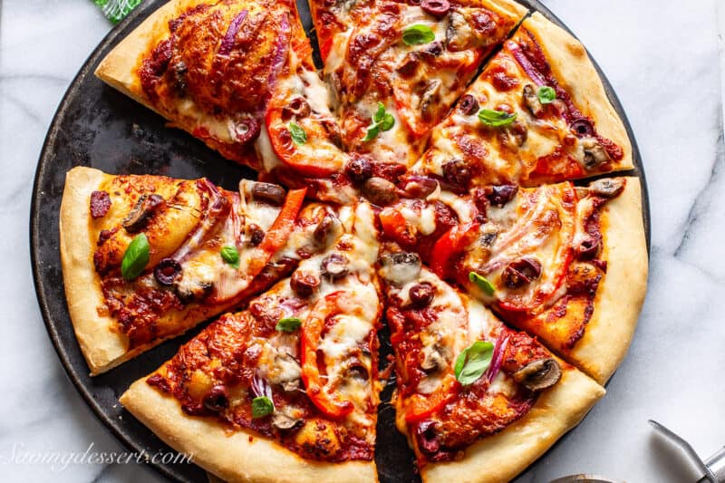 An overhead shot of a sliced vegetable pizza.