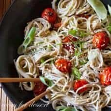 Over head view of Miso-Roasted Tomatoes with Soba Noodles in a bowl with chopsticks.