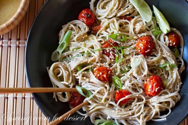 Over head view of Miso-Roasted Tomatoes with Soba Noodles in a bowl with chopsticks.
