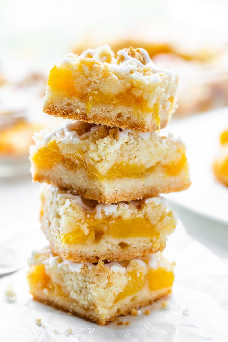 Fresh peach crumb bars in a stack