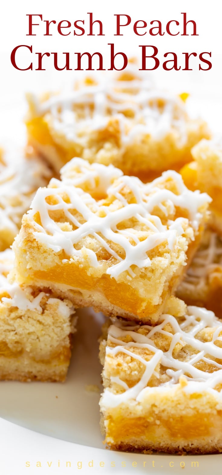 A plate stacked with fresh peach crumb bars drizzled with icing