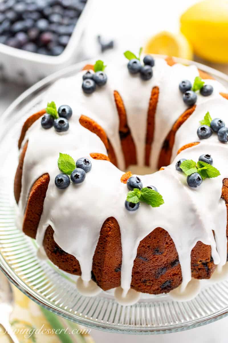 An overhead shot of a bundt style Blueberry Pound Cake on a cake stand.