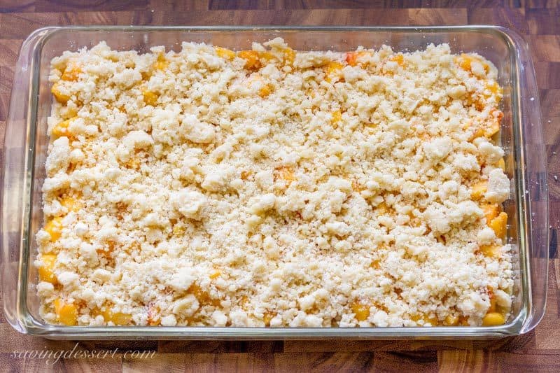 Fresh Peach Crumb Bars with a crumble topping ready to bake