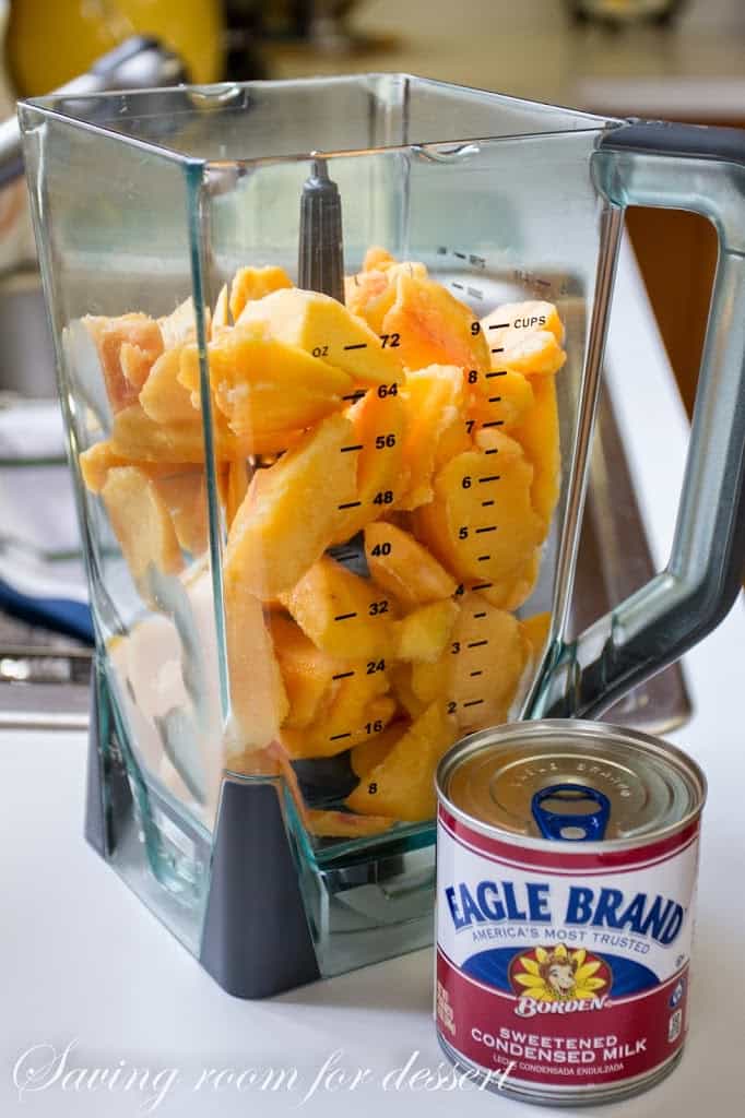 A blender filled with peaches