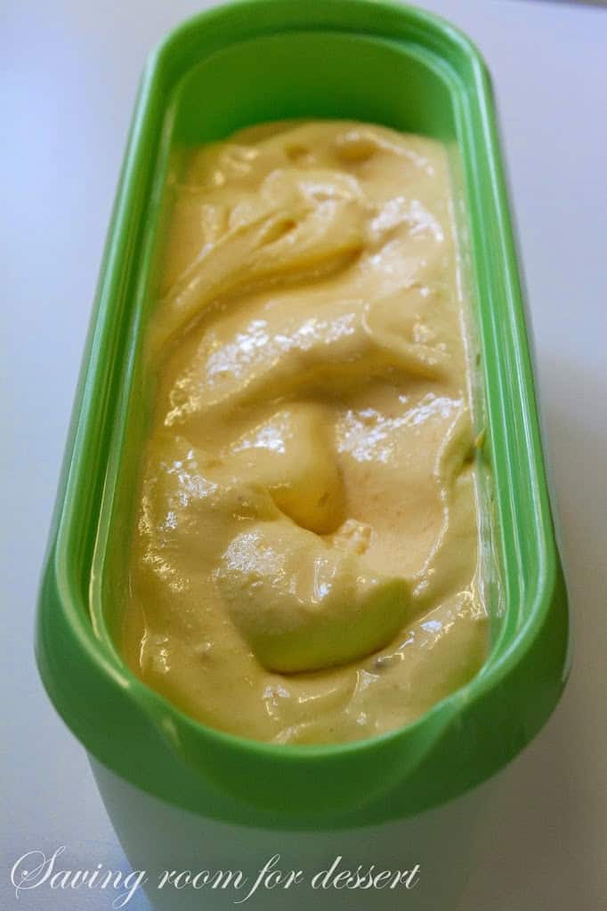 A freezer container with peach sherbet