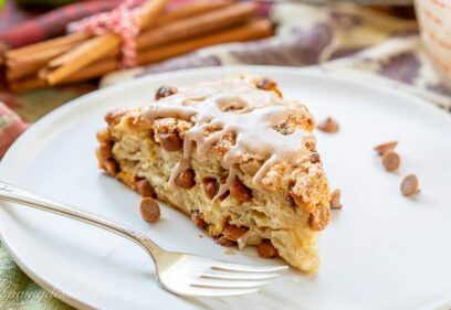 An apple scone on a plate with cinnamon chips