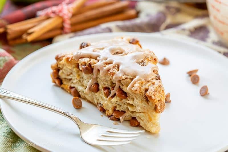 An apple scone on a plate with cinnamon chips