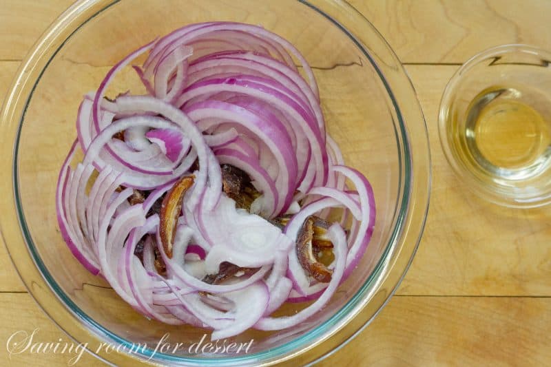 Pita Spinach Salad with Dates and Almonds - one of the best salads ever with a light olive oil dressing and vinegar soaked onions. A must try! www.savingdessert.com