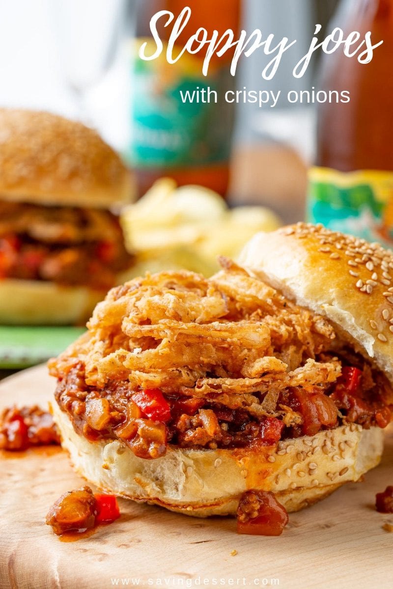 An open faced sandwich topped with crispy onions, red peppers and ground beef