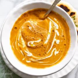 Butternut squash soup topped with a swirl of Greek yogurt served with naan bread.