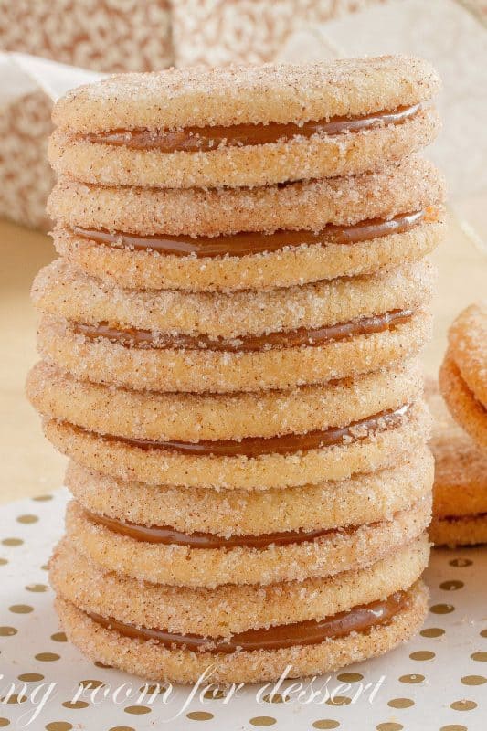 Dulce de Leche Sandwich Cookies with Cinnamon and Cardamom - a sweet, soft cookie coated with the warm flavors of cinnamon and cardamom then filled with a silky rich caramel. www.savingdessert.com #holidaycookies #cookie #dulcedeleche #sandwichcookies #savingroomfordessert