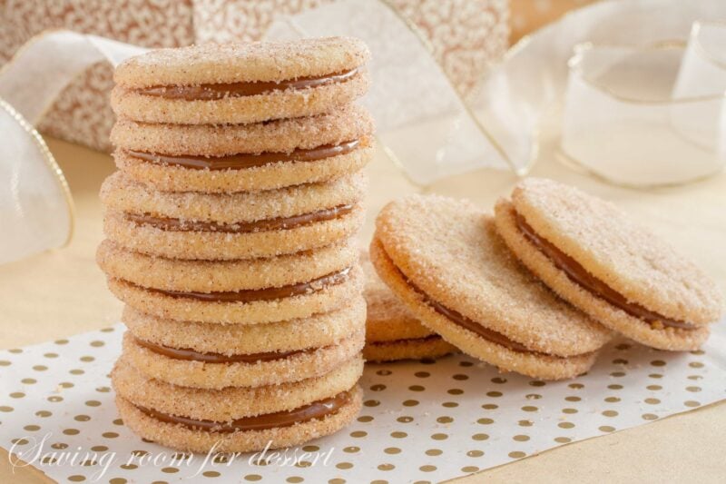 A stack of dulce de leche sandwich cookies topped with cinnamon sugar 