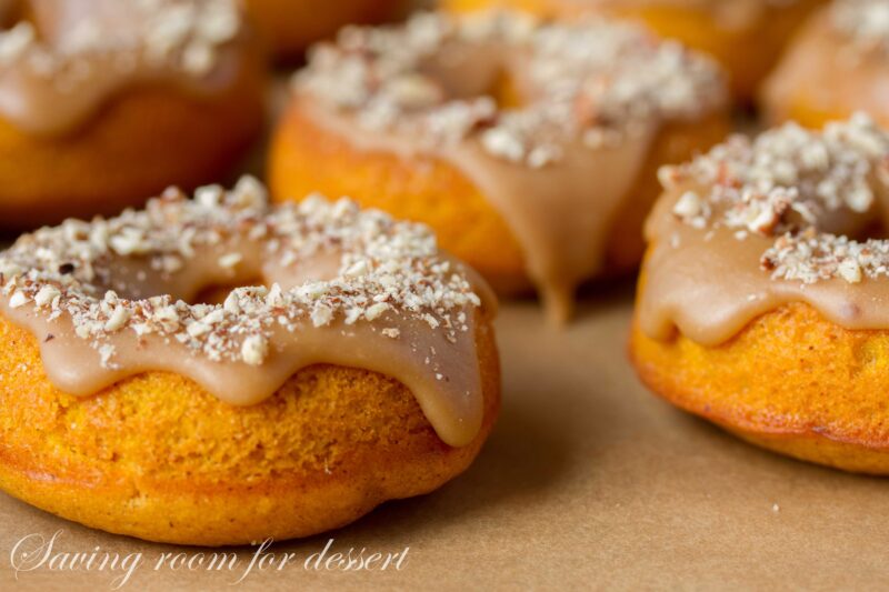 Pumpkin Donuts with Caramel Icing and Toasted Pecans | www.savingdessert.com