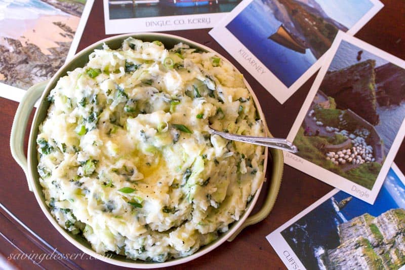 A bowl of colcannon on a table with post cards from Ireland laying about.