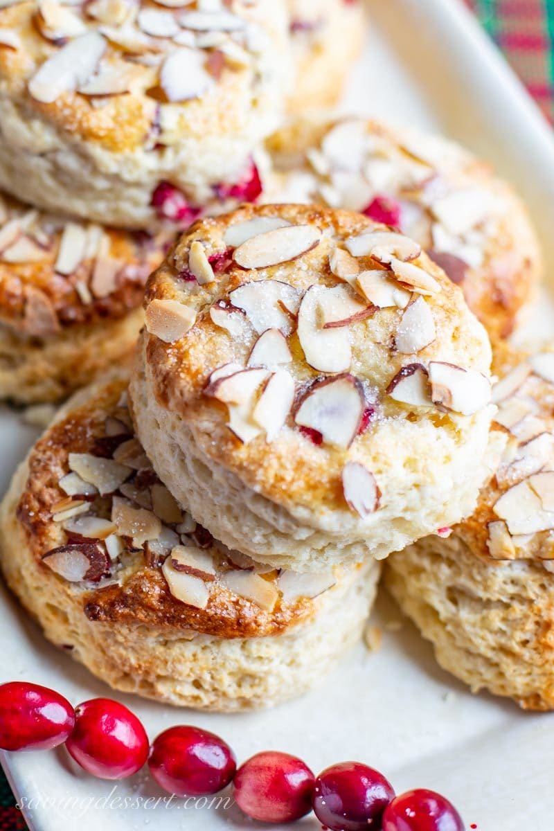 a close up of cranberry almond scones sprinkled with coarse sugar and sliced almonds