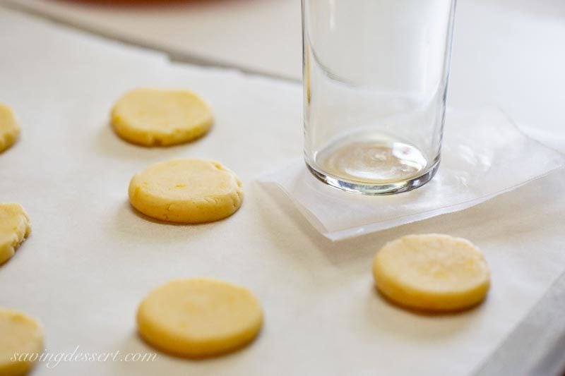lemon meltaway cookie dough pressed to flatten with the bottom of a small glass