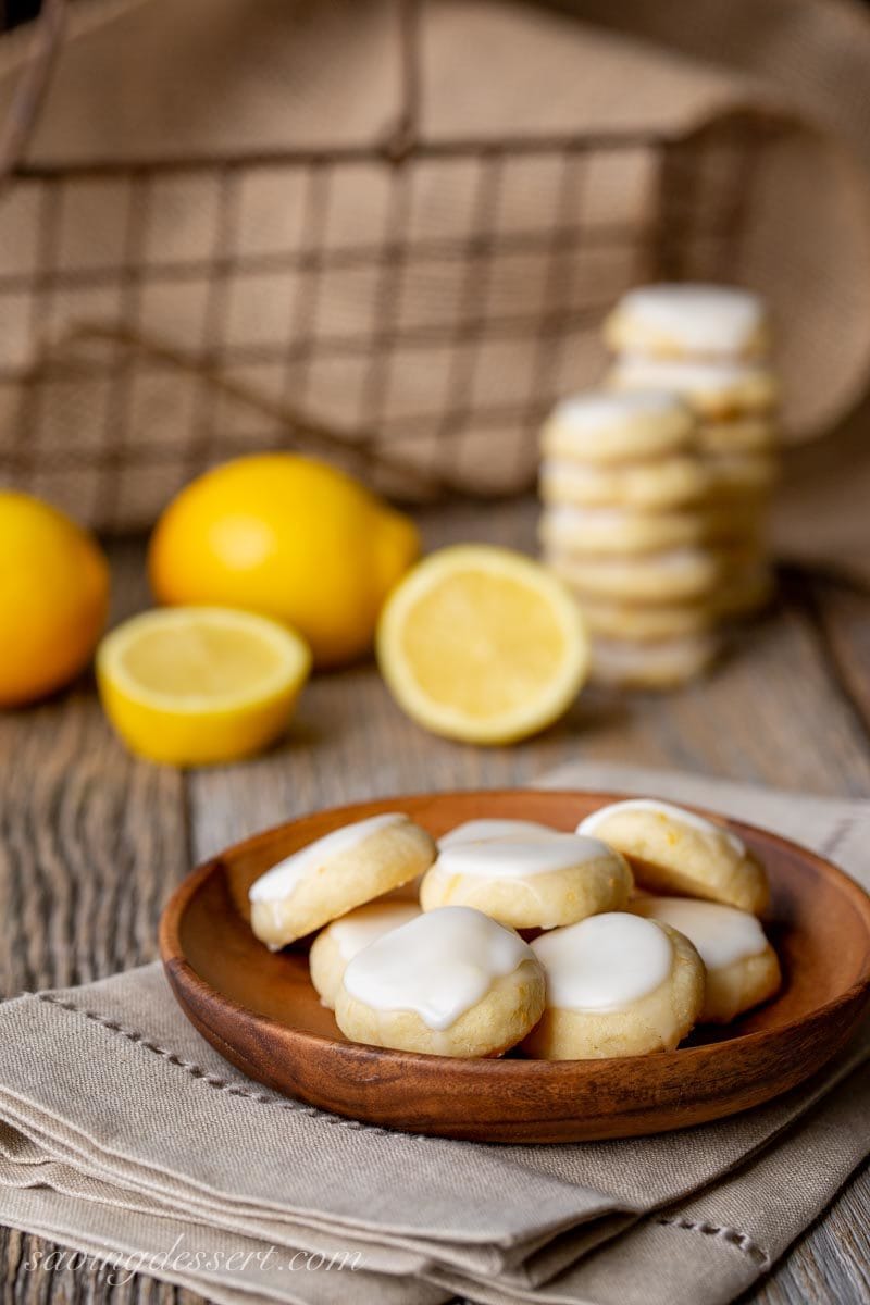 A wooden bowl of lemon meltaway cookies with icing on top