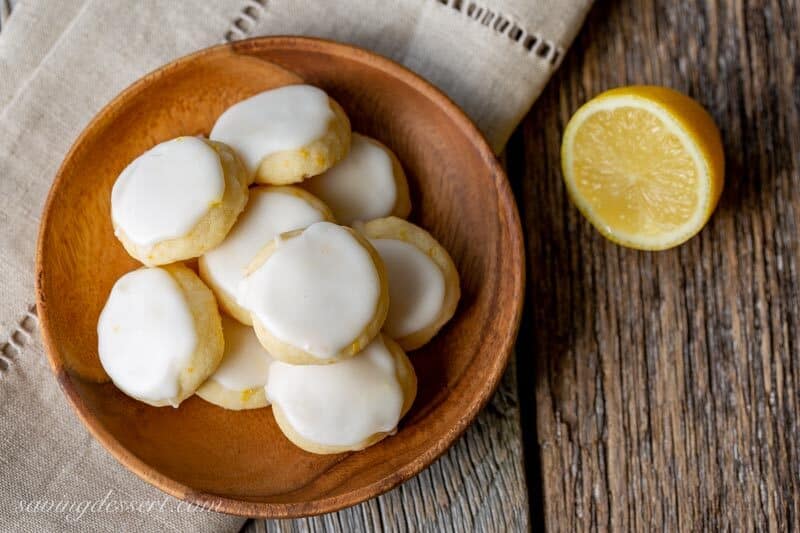 A small wooden plate filled with lemon meltaway cookies