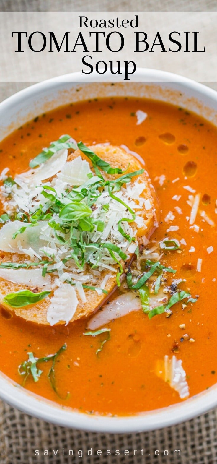 A bowl of roasted tomato basil soup with a slice of bread on top