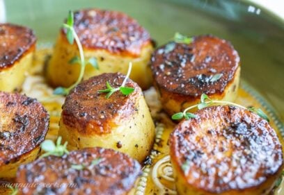 Close up of roasted potatoes with fresh thyme