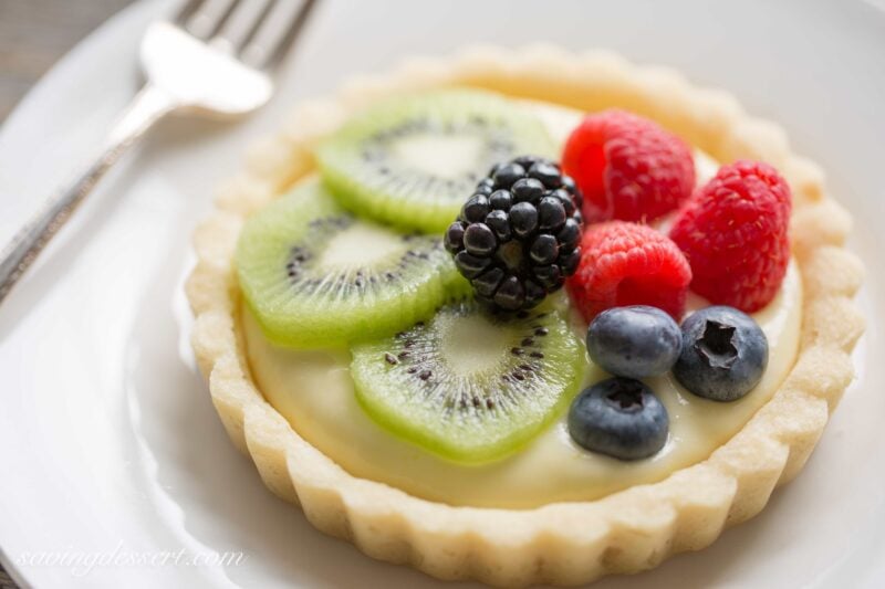 Fresh Fruit Tarts -A light fresh fruit tart with a simple shortbread crust filled with a mixture of cream cheese and lemon curd. Super simple to make and easily adaptable to your favorite fruits.