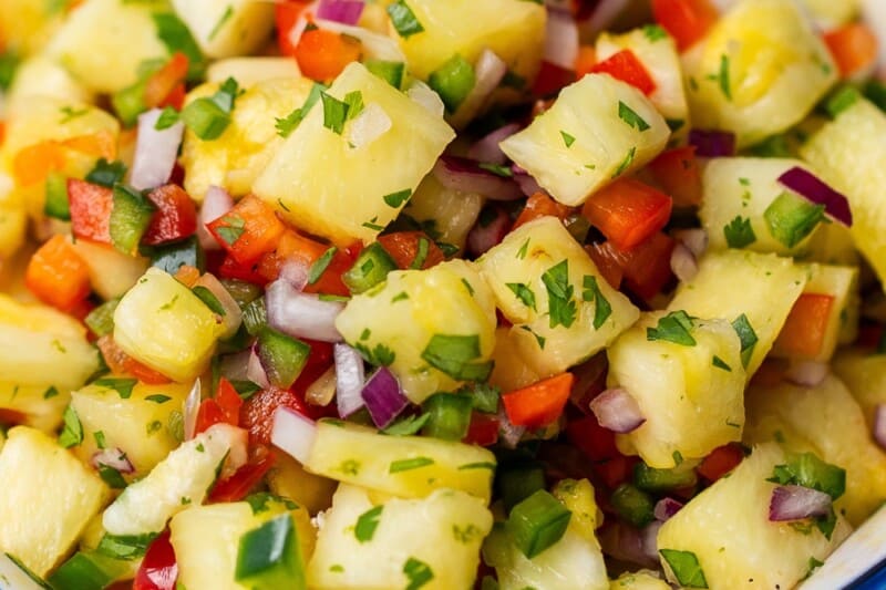 A bowl of fresh pineapple salsa with chips.