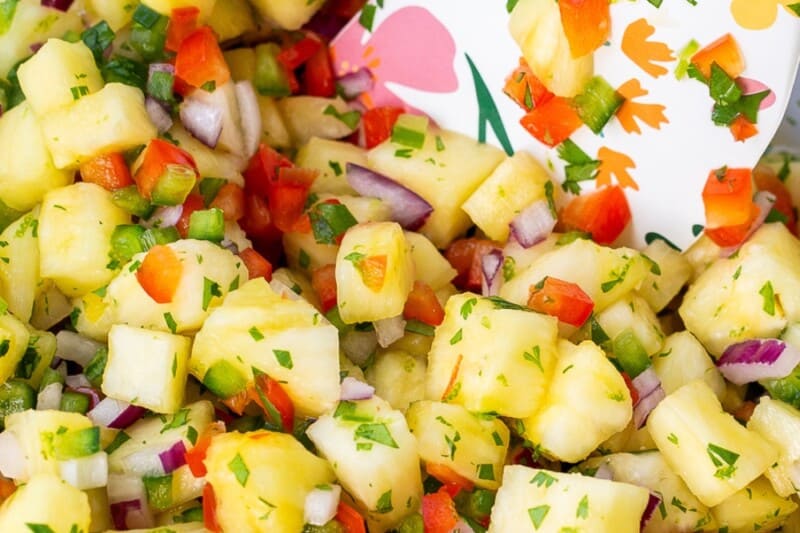 A mixing bowl filled with fresh pineapple salsa.