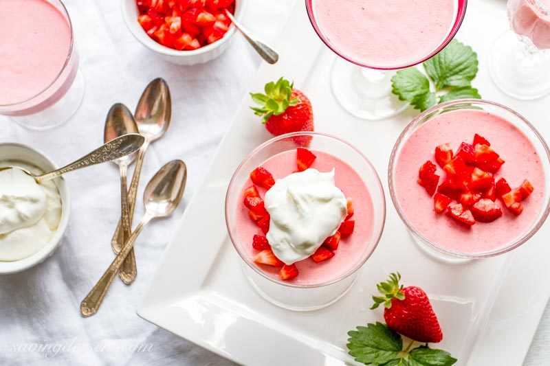 overhead view of strawberry mousse with lemon whipped cream in dessert glasses