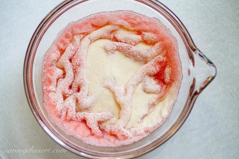 strawberry puree in a small bowl with gelatin sprinkled on top