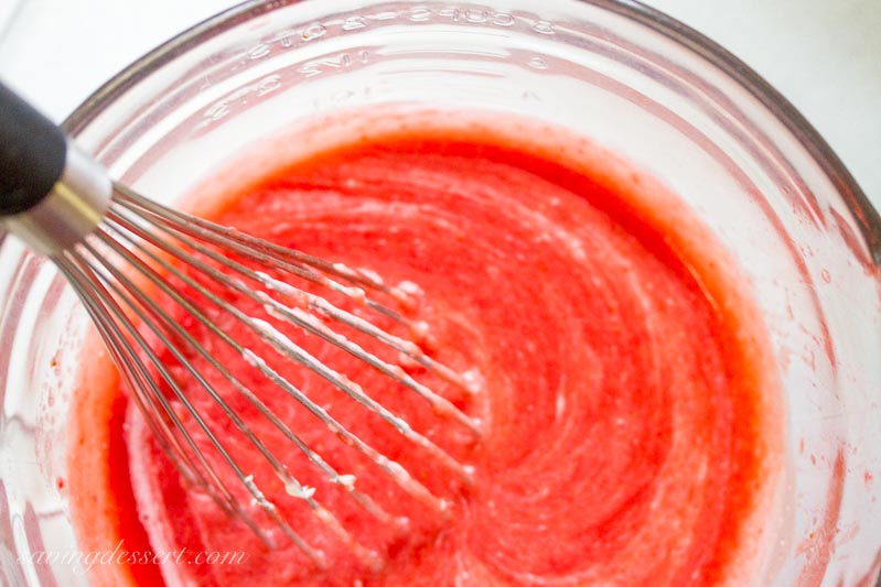 strawberry puree being whisked with cream cheese