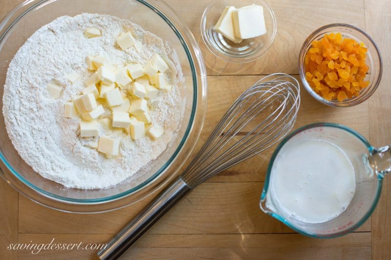 Buttery Apricot Scones ~ A light, flaky, buttery scone layered with chopped apricots and iced with an almond flavored glaze. www.savingdessert.com