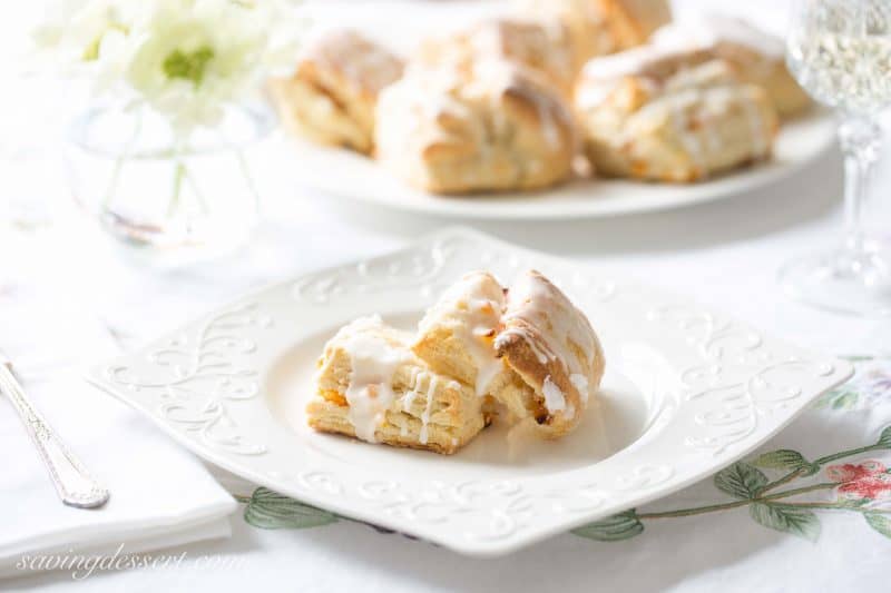 Buttery Apricot Scones ~ A light, flaky, buttery scone layered with chopped apricots and iced with an almond flavored glaze. www.savingdessert.com