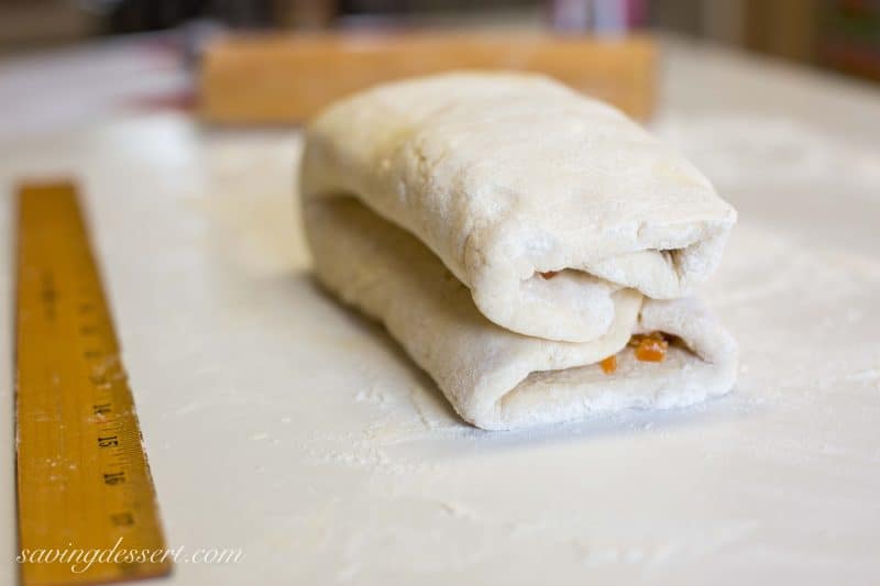 Buttery Apricot Scones ~ A light, flaky, buttery scone layered with chopped apricots and iced with an almond flavored glaze. www.savingdessert.com